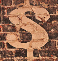 dollar sign on brick