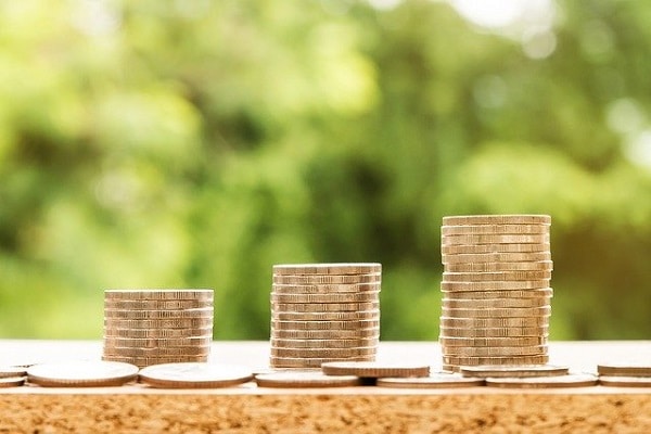 three stacks of coins have varying heights -- will the investment returns of real estate vs stocks have differences, too?