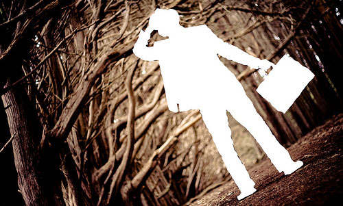 shadow man in woods with briefcase